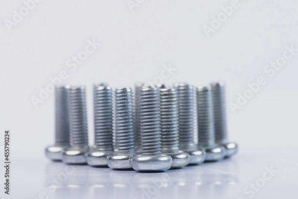 Fototapeta Screws on a white isolated background. Bolts on white isolated background. 