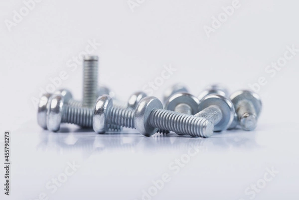 Fototapeta Screws on a white isolated background. Bolts on white isolated background. 