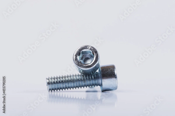 Fototapeta Screws on a white isolated background. Bolts on white isolated background. 