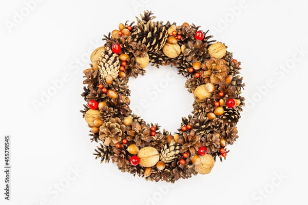 Fototapeta Autumn wreath of cones, nuts, and berries. Creative composition, the handmade