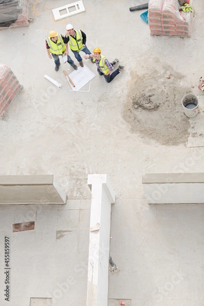 Fototapeta Overhead view of construction workers at construction site