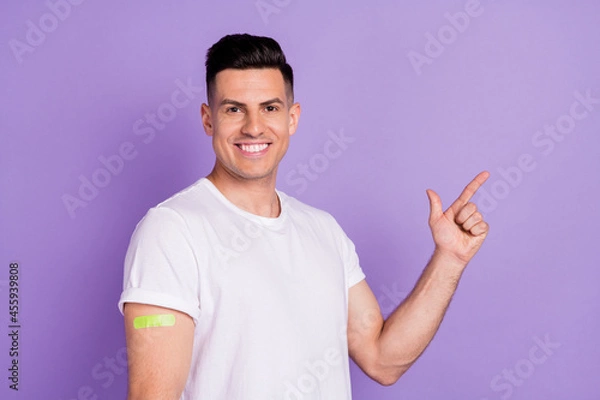 Fototapeta Profile side photo of young man point finger empty space ad advise vaccination plaster isolated over violet color background