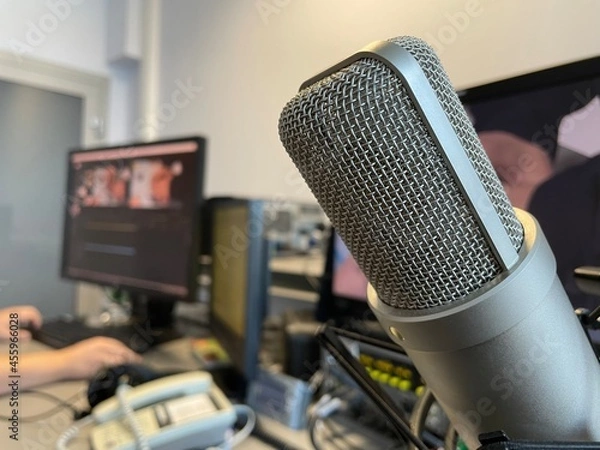 Fototapeta microphone hangs on the background of monitors