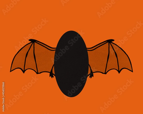 Fototapeta Bat wings flying with card stock body and room for text. Halloween orange and black colors.