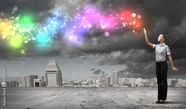 Fototapeta Businessman with colourful light beam in his hands