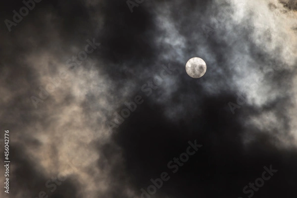 Fototapeta un hidden behind dark storm clouds