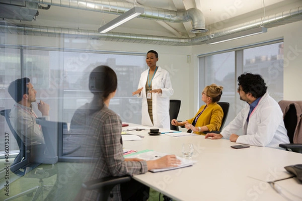 Fototapeta Businesswoman leading conference room meeting