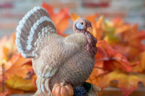 Obraz Vintage clay turkey with colorful autumn leaves. Seasonal display for Thanksgiving and Halloween.
