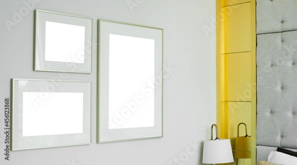 Fototapeta three different size of blank picture frames mockup on white wall background in the bedroom