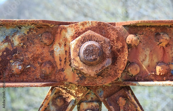 Obraz Front view of big old rusty bolt and nut on weathered background