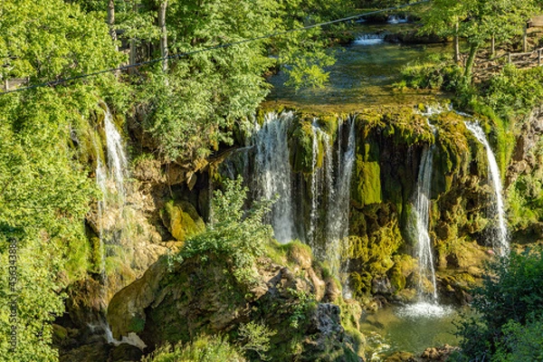 Obraz Beautiful small stream going into a romantic waterfall in lush greenery