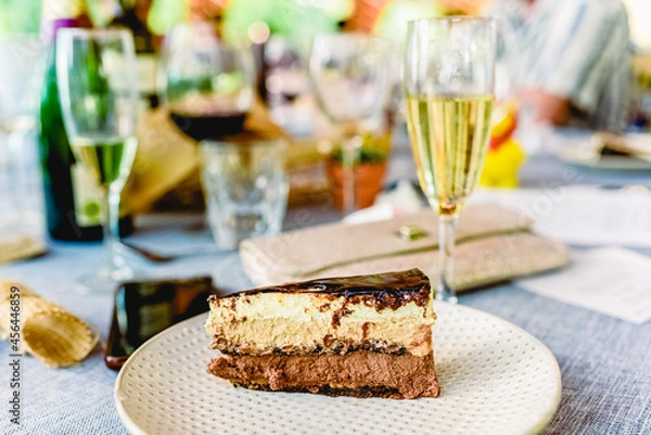 Fototapeta A piece of delicious cake cut on a plate in a fancy restaurant.
