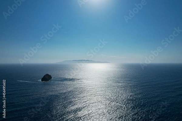 Fototapeta Deep blue sea. View of the sea horizon from above with Elba island visible on the horizon, photographed with drone. Porto Santo Stefano, Monte Argentario, Italy.