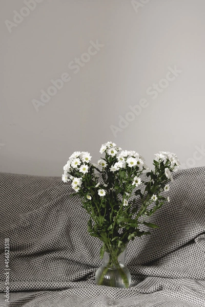 Obraz bouquet of white flowers in bed bedroom with  natural bed sheets blanket 
crumpled