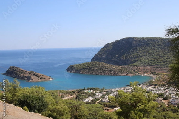 Obraz Bay and island view with hills and trees around it.