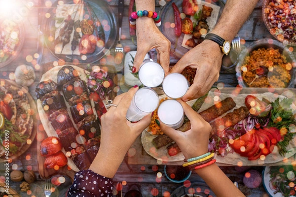 Fototapeta Close up view of family members having fun and toasting with rakı 