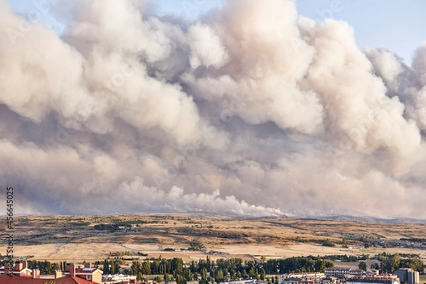 Fototapeta Dark and dense smoke clouds from a fire in Spain. Close-up of a large smoke cloud in the sky from a forest fire