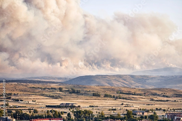 Fototapeta Dark and dense smoke clouds from a fire in Spain. Close-up of a large smoke cloud in the sky from a forest fire