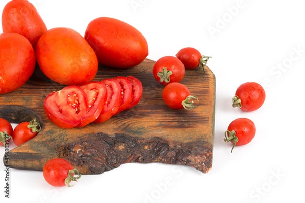 Obraz organic red tomatoes on wooden background on white background