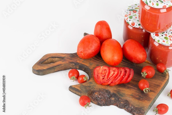 Obraz tomato sauces in handmade jar on wooden background and white background