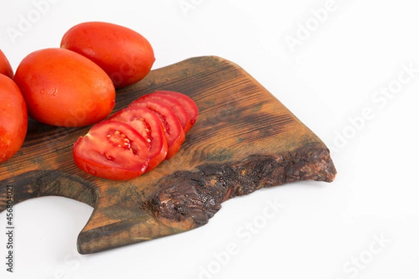 Obraz organic red tomatoes on wooden background on white background