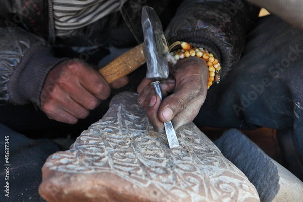 Fototapeta Making Tibetan Buddhist Mani Stone - stone with holy mantras 