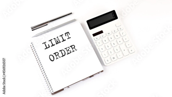 Fototapeta Notepad with text LIMIT ORDER with calculator and pen. White background. Business