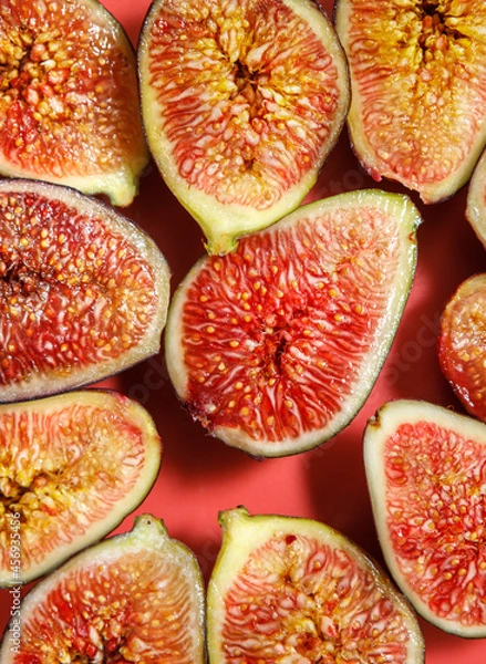Fototapeta A slice of delicious figs on a plate. Top view.
