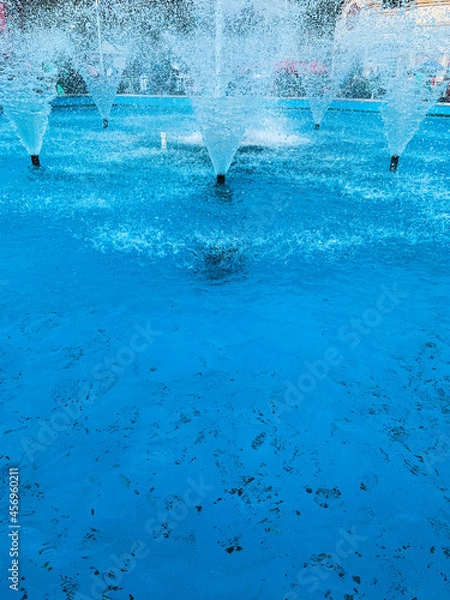 Obraz Closeup of decorative water fountains in pool. 