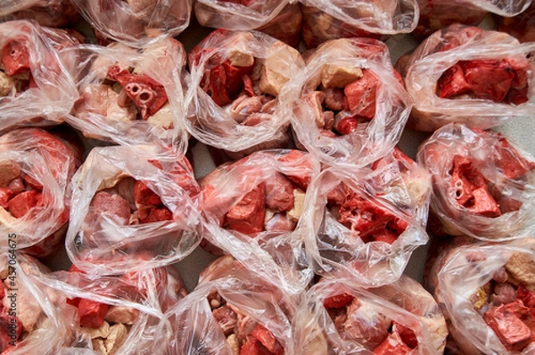 Fototapeta preparation of food for raw feeding. BARF food for dogs and cats. Packaging of food for animals.