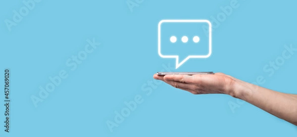 Fototapeta Businessman holding a message icon, bubble talk notification sign in his hands. Chat icon, sms icon, comments icon, speech bubbles