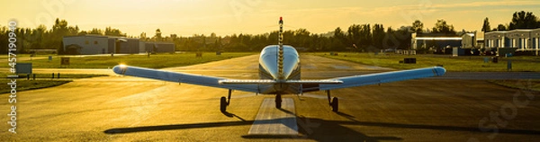 Obraz Small plane ready to take off at sunrise.