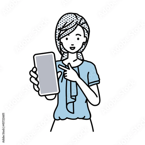 Obraz 立ってスマートフォンを指差してこちらに向けて見せているオフィスカジュアルの女性