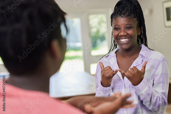 Obraz Teenage Girl And Boy Having Conversation Using Sign Language At Home