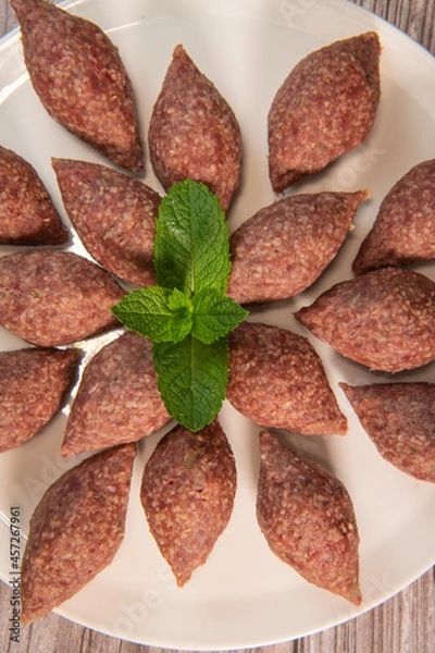 Fototapeta Traditional kebbe and pita bread on big round plate in lebanese restaurant. High quality photo