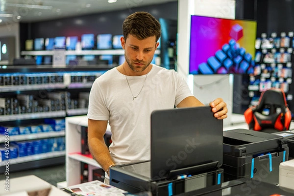 Fototapeta Man choosing hardware in electronics store