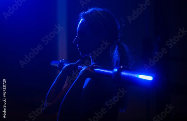 Fototapeta Cross fit training. Muscular woman with barbell. Sporty girl squats with barbell training. Sport, bodybuilding, lifestyle concept. Fit young woman in great shape lifting barbells. Silhouette