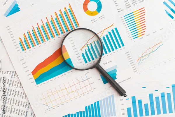 Fototapeta Business graphs, charts and magnifying glass on table. Financial development, Banking Account, Statistics