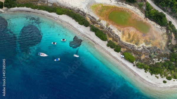 Fototapeta Aerial drone photo of exotic turquoise sandy beach forming a blue lagoon in tropical destination island bay