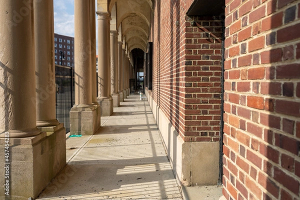 Obraz Outdoor corridor pathway with arched columns. 
