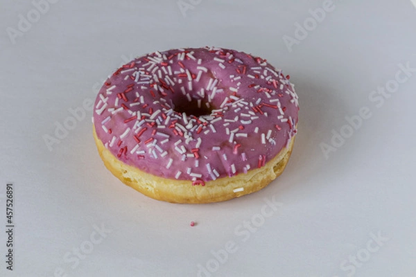 Obraz Tasty glazed raspberry donut with topping.