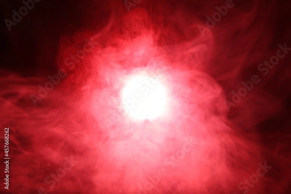 Fototapeta Artificial magic smoke in red light on black background