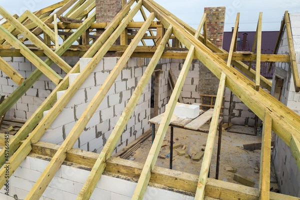 Obraz Aerial view of a private house with aerated concrete brick walls and wooden frame for future roof.