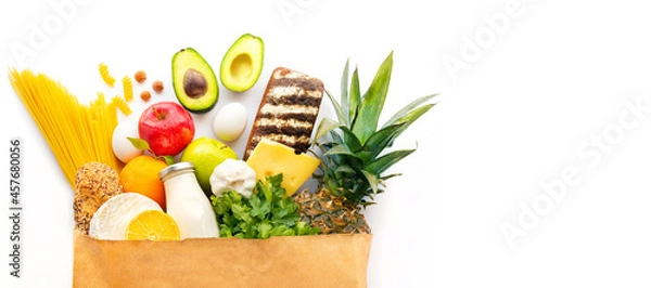 Obraz Healthy food products in a craft package. A bag of groceries. Healthy food delivery. Delivery of useful products in a croft package. Food delivery for the party. Diet food. Healthy food at home. 