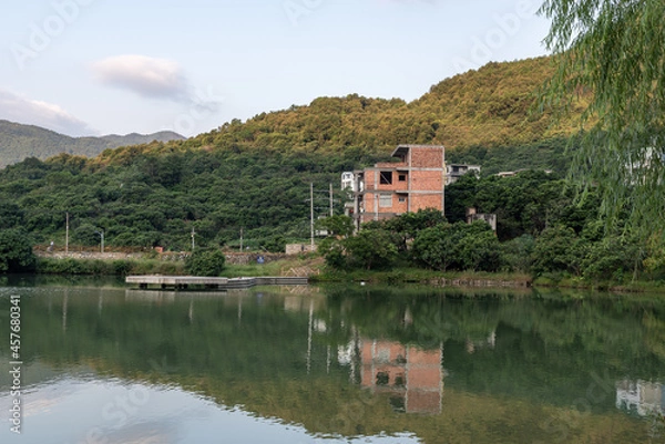 Obraz The lake reflects the mountains and villages