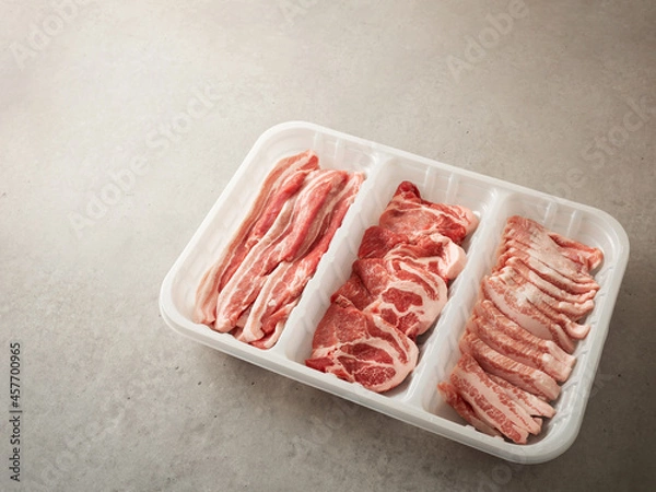 Obraz Assorted pork cuts on trays for packaging