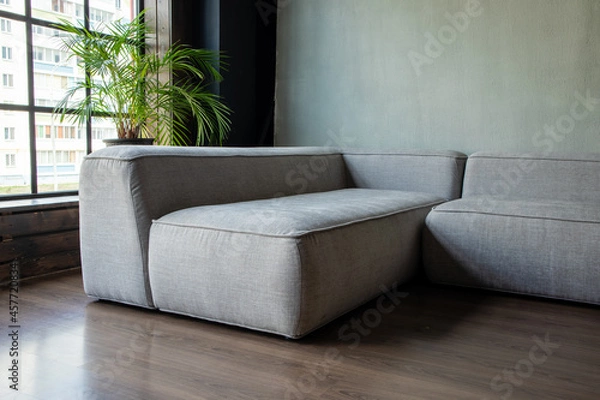 Obraz soft upholstered light sofa with modules in the interior with a panoramic window