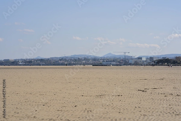Fototapeta Beautiful bright view on South Dublin and the Mountains seen from Sandymount Beach, Dublin, Ireland during lowest tide. Walking people. Open spaces. High resolution