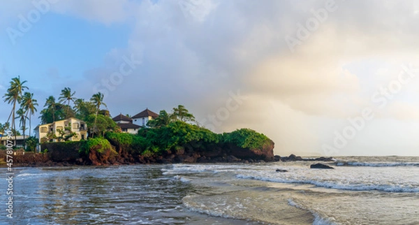 Obraz O Pescador beach resort with trees and clouds at sunset, Dona Paula Beach, Goa, India