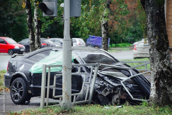 Fototapeta car crashed into a road fence next to a tree